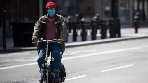 Getty Images Man with face covering on mask