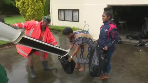 Reuters Residents fill bags with sand in preparation for possible flooding as a result of storm Gita, 20 February 2018