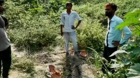 Anoop Kumar Mishra Diggers with the remains of the pot