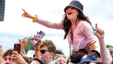 Jane Barlow/PA Wire The TRNSMT crowd get into the festival mood early on Friday as the Bootleg Beatles take to the stage