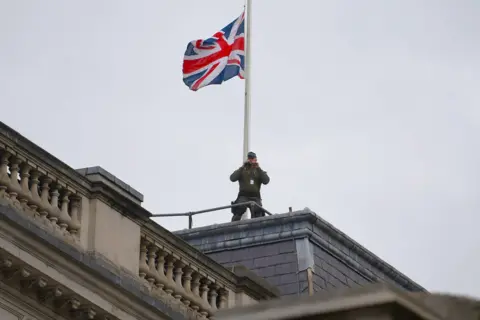 NEIL HALL/EPA-EFE/REX/Shutterstock Armed police can be seen on rooftops