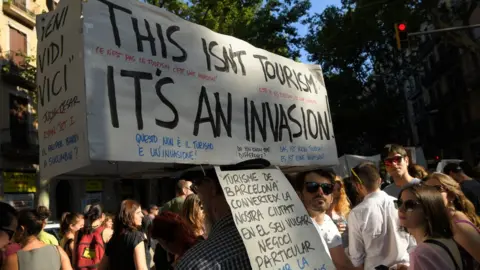 Getty Images Anti-tourist protesters in Barcelona in June 2017