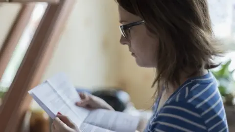 Woman reads official letter