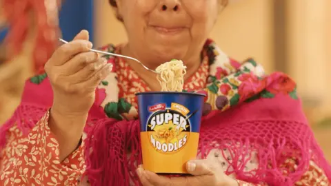 Premier foods Woman eating super noodles