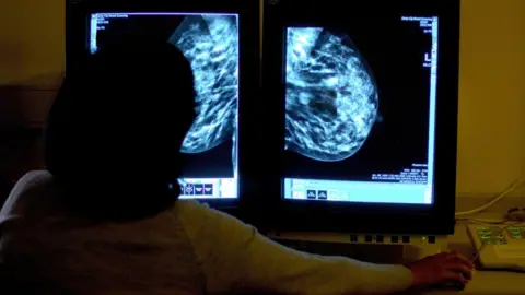 PA Media Breast cancer screening on a computer