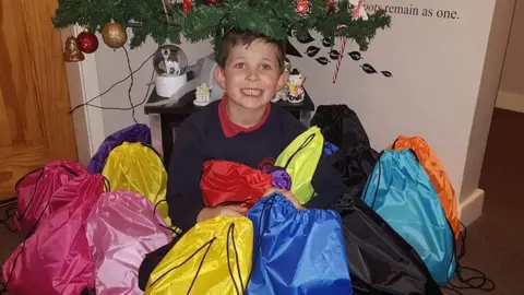 Family photo Mason with bags for homeless collection