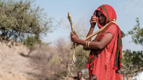 A woman standing in the field