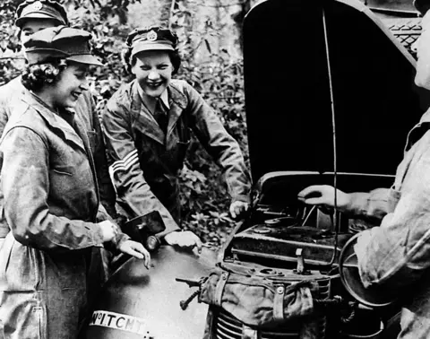 PA Princess Elizabeth receives vehicle maintenance instruction on an Austin 10 Light Utility Vehicle while serving with No 1 MTTC at Camberley, Surrey. World War Two