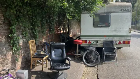 Rubbish next to a caravan