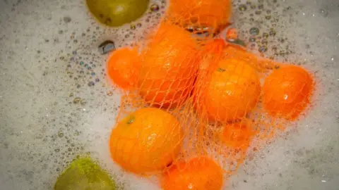 Steven Murray Oranges in washing up bowl