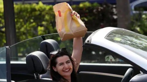 PA Media Woman brandishes McDonald's bag