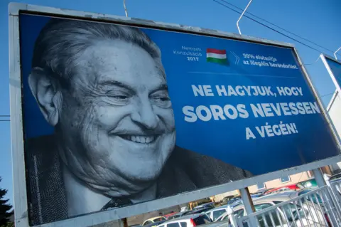 Getty Images A billboard tells Hungarians not to let Soros "have the last laugh"