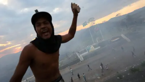 Reuters A protestor holds a projectile