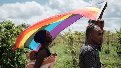 YASUYOSHI CHIBA LGBT refugees from South Sudan, Uganda and DR Congo walk on the way to their protest to demand their protection at the office of the United Nations High Commissioner for Refugees (UNHCR) in Nairobi, Kenya, on May 17, 2019. - According to them, they have fled from Kakuma and Dadaab refugee camps in northern Kenya to avoid life threatened incidents and stayed in front of UNHCR office building in Nairobi since January.
