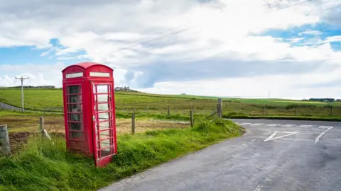 Getty Images A phone box at the side of a road