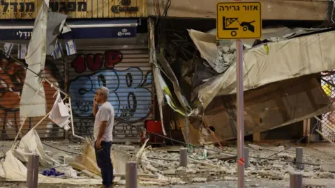 Getty Images Damaged shop in Tel Aviv, hit by a rocket fired by Hamas on 7 October