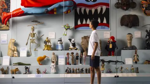 Young V&A Boy looks at toys