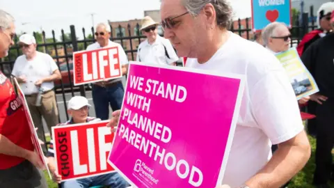 SAUL LOEB/AFP/Getty Images A supporter of Planned Parenthood stands near an anti-abortion demonstrators as they hold a protest outside the Planned Parenthood Reproductive Health Services Center in St. Louis, Missouri, May 31, 2019