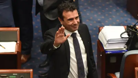 AFP Macedonian Prime Minister Zoran Zaev Waves to journalists after Macedonian lawmakers voted to change the country's name