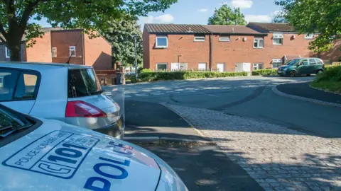 SWNS The bonnet of a police car parked at the scene