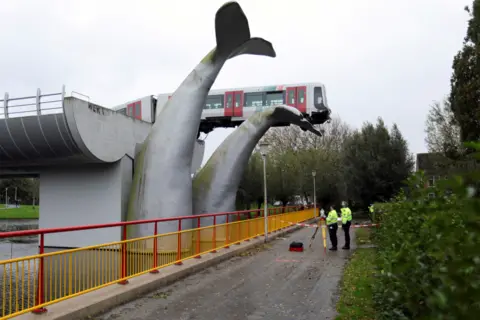 Eva Plevier / Reuters A metro train rests precariously on an art installation of a whale in Spijkenisse, near Rotterdam, Netherlands, 2 November 2020