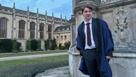 George Baldock George in his robes outside the university