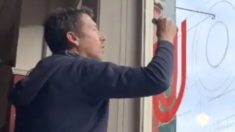 Darren Smith Darren Smith painting pub window