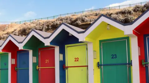 Getty Images Beach huts in Barry Island
