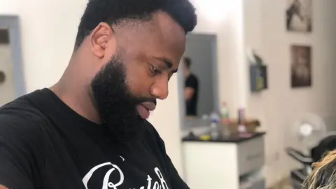 Sylvester King cutting hair