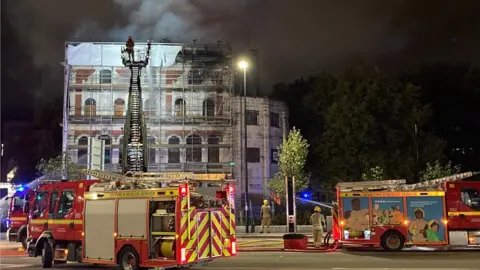 Burning Grosvenor Hotel and fire engines