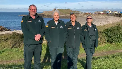 St John Ambulance and Rescue Service Four ambulance crew members