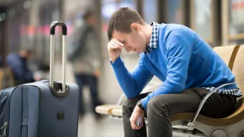 Getty Images man waiting at airport