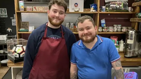 BBC News/Munaza Rafiq Cafe Track employees, Jack and Alfie, behind the coffee counter.