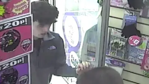 Matthew Cassidy entering a shop behind his murderer