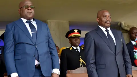 Reuters FILE PHOTO: Democratic Republic of Congo"s outgoing President Joseph Kabila and his successor Felix Tshisekedi stand during an inauguration ceremony in Kinshasa, Democratic Republic of Congo, January 24, 2019