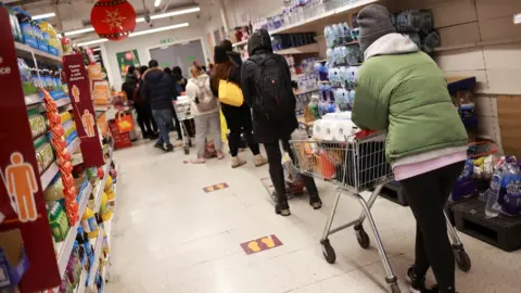 Reuters People shop at a Sainsbury's store