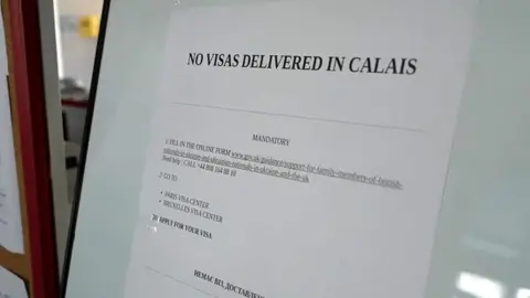 Sign on door saying no visas in Calais