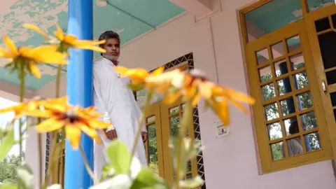 Mukhtar Zahoor Bashir Ahmad Bhat at the entrance of his brother’s house.