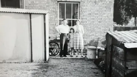 Supplied Bert and Nancy Gifford and their daughter Mary in the garden of their The Mead home in the 1950s