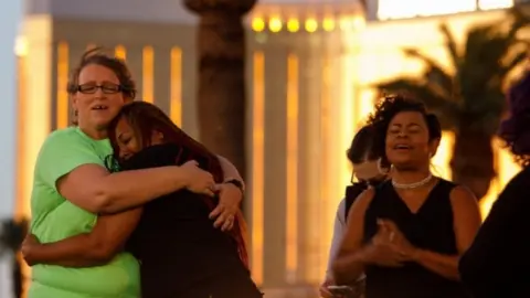 EPA Women at a vigil outside the Mandalay bay hotel