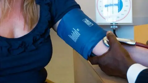 Science Photo Library GP measuring blood pressure