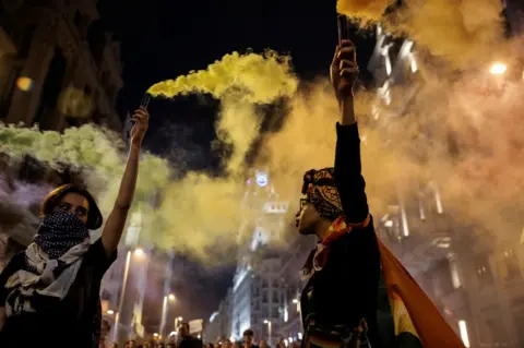 Susana Vera/REUTERS Women with flares during a march to mark the International Day Against Homophobia, Transphobia, and Biphobia, in Madrid, Spain, 17 May 2018.