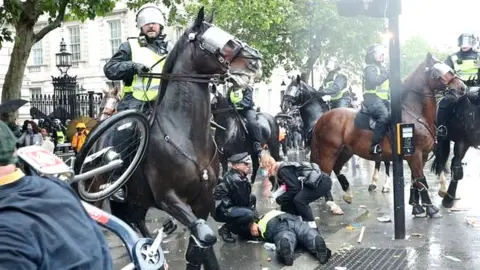 Press Association Fourteen police officers were injured during protests in London on Saturday