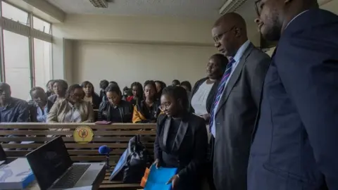 Getty Images Kenyan lawyer, Mercy Mutemi (seated 4th R) along with fellow counsel during a pre-trial hearing in the case