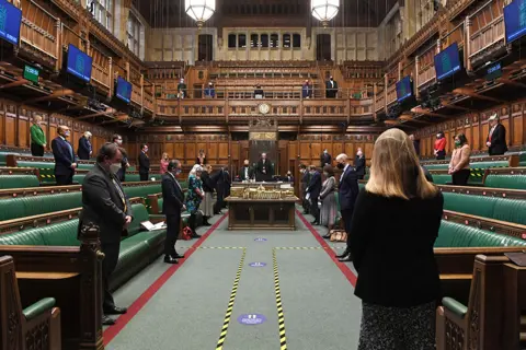 UK Parliament/Jessica Taylor MPs stand in silence in the House of Commons