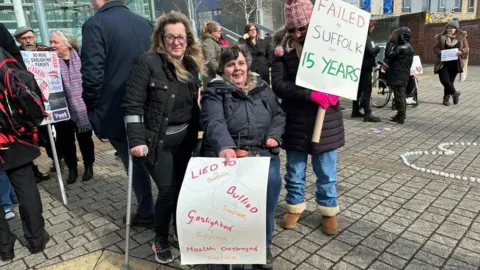 Anna Louise Claydon/BBC Protesters outside Endeavour House in Ipswich