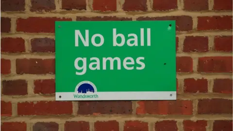 Getty Images No Ball Games sign in Wandsworth with white letters on a green background