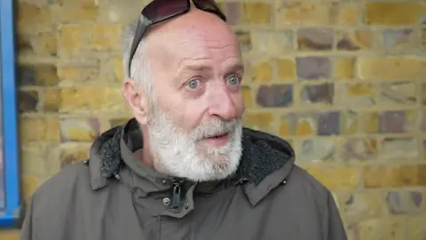 Jamie Niblock/BBC Frank Armstrong, 59, from Harlow, queuing at a food bank charity