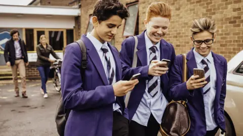 Getty Images Pupils on phones