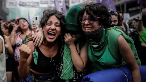 Women supporting the legalisation bill celebrate the vote